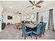 Bright dining room featuring a ceiling fan, modern decor and a six place table setting at 3811 Lana Ave, Davenport, FL 33897