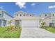 Charming two-story home featuring a spacious two-car garage and a well-manicured front yard at 3811 Lana Ave, Davenport, FL 33897