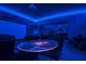 Home theater room with movie screen, blue led lights, and bar style table at 3811 Lana Ave, Davenport, FL 33897