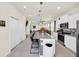 Open kitchen with granite countertops, white cabinetry, stainless appliances, and adjacent dining at 3811 Lana Ave, Davenport, FL 33897