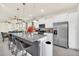 Kitchen features stainless appliances, granite countertops and an island with bar stool seating at 3811 Lana Ave, Davenport, FL 33897