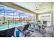 Outdoor screened lanai with dining table and view of the sparkling pool at 3811 Lana Ave, Davenport, FL 33897