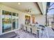 Covered patio with dining table overlooking the pool and backyard at 3811 Lana Ave, Davenport, FL 33897