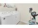 Laundry room with a white washer and dryer and wire rack at 3811 Lana Ave, Davenport, FL 33897