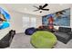 Cozy living room featuring beanbag chairs, comfortable sofa, and a large TV for entertainment at 3811 Lana Ave, Davenport, FL 33897