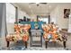 Stylish living room with decorative chairs open to the kitchen, and a view of the dining area at 3811 Lana Ave, Davenport, FL 33897