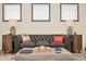 Stylish living room featuring a comfortable leather sofa, wood accents, and decorative lamps at 3811 Lana Ave, Davenport, FL 33897