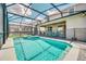 Backyard swimming pool and spa surrounded by a screened enclosure at 3811 Lana Ave, Davenport, FL 33897