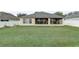 Large backyard featuring a well-maintained lawn, providing ample space for outdoor activities and leisure, screened-in lanai at 3995 Sw 57Th Ct, Ocala, FL 34474