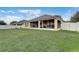 Spacious backyard featuring lush green grass, ideal for recreation with a screened in back porch and white fence at 3995 Sw 57Th Ct, Ocala, FL 34474