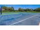 Community basketball court with clear blue and green color tones and lighting. Perfect for friendly outdoor matches at 3995 Sw 57Th Ct, Ocala, FL 34474