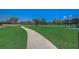 Manicured lawn leads to a community basketball court, perfect for active residents and outdoor recreation at 3995 Sw 57Th Ct, Ocala, FL 34474