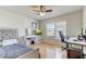 Bedroom with hardwood floors, a large window, and a ceiling fan at 3995 Sw 57Th Ct, Ocala, FL 34474