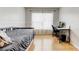 Light-filled bedroom with hardwood floors and a large window at 3995 Sw 57Th Ct, Ocala, FL 34474