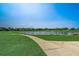 A scenic view of the community pond and sidewalk perfect for a stroll or relaxation at 3995 Sw 57Th Ct, Ocala, FL 34474
