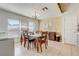 Dining room area with tile flooring, a chandelier, a large window, and traditional wood table and chairs at 3995 Sw 57Th Ct, Ocala, FL 34474