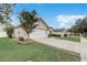 Exterior showing a two-car garage, wide driveway bordered with brick, and landscaping to enhance curb appeal at 3995 Sw 57Th Ct, Ocala, FL 34474