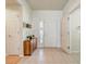 Bright foyer featuring tiled floors, a decorative cabinet, and a view of the front door with glass inserts at 3995 Sw 57Th Ct, Ocala, FL 34474