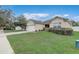 Residential home featuring a well-kept lawn, attractive landscaping, and a two-car garage in a friendly neighborhood at 3995 Sw 57Th Ct, Ocala, FL 34474