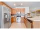 Modern kitchen with stainless steel appliances, tile backsplash, wood cabinets, and ample counter space for cooking at 3995 Sw 57Th Ct, Ocala, FL 34474