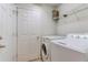 Laundry room featuring a washing machine, dryer, and a door to another room at 3995 Sw 57Th Ct, Ocala, FL 34474