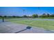 Community tennis courts with lighting poles set against clear blue skies offer a great place for a match at 3995 Sw 57Th Ct, Ocala, FL 34474