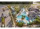 Overhead shot of a community pool featuring an outdoor bar, lazy river and lush landscaping at 4374 Rhyme St, Kissimmee, FL 34746