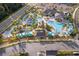 A captivating aerial view of the community pool area with lazy river and sun loungers at 4374 Rhyme St, Kissimmee, FL 34746