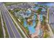 Community amenities aerial view showcases the lazy river, pool, and surrounding greenery at 4374 Rhyme St, Kissimmee, FL 34746
