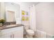 Bright bathroom featuring a single sink vanity with grey countertop and framed Minion wall art at 4374 Rhyme St, Kissimmee, FL 34746