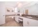 Refined bathroom features double sinks, a vanity, a tub, and stylish neutral tiling at 4374 Rhyme St, Kissimmee, FL 34746