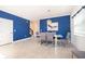 Stylish dining area featuring a blue accent wall, tile floors, and modern furnishings at 4374 Rhyme St, Kissimmee, FL 34746