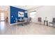 Elegant dining area with a vibrant blue accent wall, modern light fixture, and neutral decor at 4374 Rhyme St, Kissimmee, FL 34746