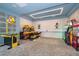 Fun game room complete with arcade machines, patterned floors, and vibrant decor at 4374 Rhyme St, Kissimmee, FL 34746