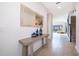 Inviting hallway with tile flooring, a decorative table, and a glimpse into the living room at 4374 Rhyme St, Kissimmee, FL 34746
