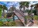 Walkway over a lazy river with lush tropical landscaping providing a scenic and relaxing atmosphere at 4374 Rhyme St, Kissimmee, FL 34746