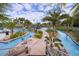 Picturesque lazy river with lush tropical landscaping creating a serene and inviting atmosphere at 4374 Rhyme St, Kissimmee, FL 34746