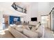 Bright, open-concept living room with modern decor, flowing into dining area with backyard access at 4374 Rhyme St, Kissimmee, FL 34746