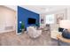 Comfortable living room with blue accent wall, plush seating, and natural lighting at 4374 Rhyme St, Kissimmee, FL 34746