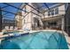 Relaxing screened-in pool area features a pristine pool and a soothing spa at 4374 Rhyme St, Kissimmee, FL 34746