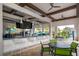 Outdoor pool bar featuring counter seating, ceiling fans, and views of the pool area at 4374 Rhyme St, Kissimmee, FL 34746
