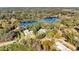 Gorgeous aerial view of the house, with a beautiful lake and lush green trees at 530 Mckenzie Rd, Lake Helen, FL 32744