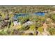 Gorgeous aerial view of the house, with a beautiful lake and lush green trees at 530 Mckenzie Rd, Lake Helen, FL 32744