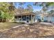 Cozy screened-in back porch surrounded by landscaping, perfect for relaxation and enjoying nature at 530 Mckenzie Rd, Lake Helen, FL 32744