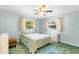 Cozy bedroom featuring a ceiling fan, two windows, and calming light blue walls at 530 Mckenzie Rd, Lake Helen, FL 32744