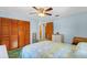 Cozy bedroom featuring a wooden closet, dresser, and calming light blue walls at 530 Mckenzie Rd, Lake Helen, FL 32744