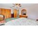 Spacious bedroom featuring wood closet doors and a large dresser with mirror, providing ample storage at 530 Mckenzie Rd, Lake Helen, FL 32744