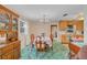 Dining area with a view of the kitchen, with a dining table set under a chandelier, ready for gatherings at 530 Mckenzie Rd, Lake Helen, FL 32744