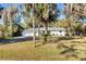 Inviting single-story home with a paved driveway, lush lawn and beautiful oak trees at 530 Mckenzie Rd, Lake Helen, FL 32744