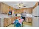 Eat-in kitchen with wood cabinets, white countertop, and appliances at 530 Mckenzie Rd, Lake Helen, FL 32744